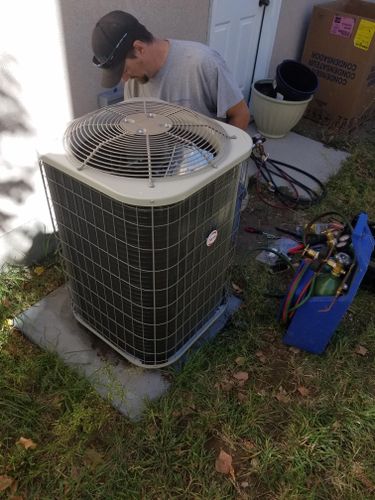 Greg servicing an air conditioner