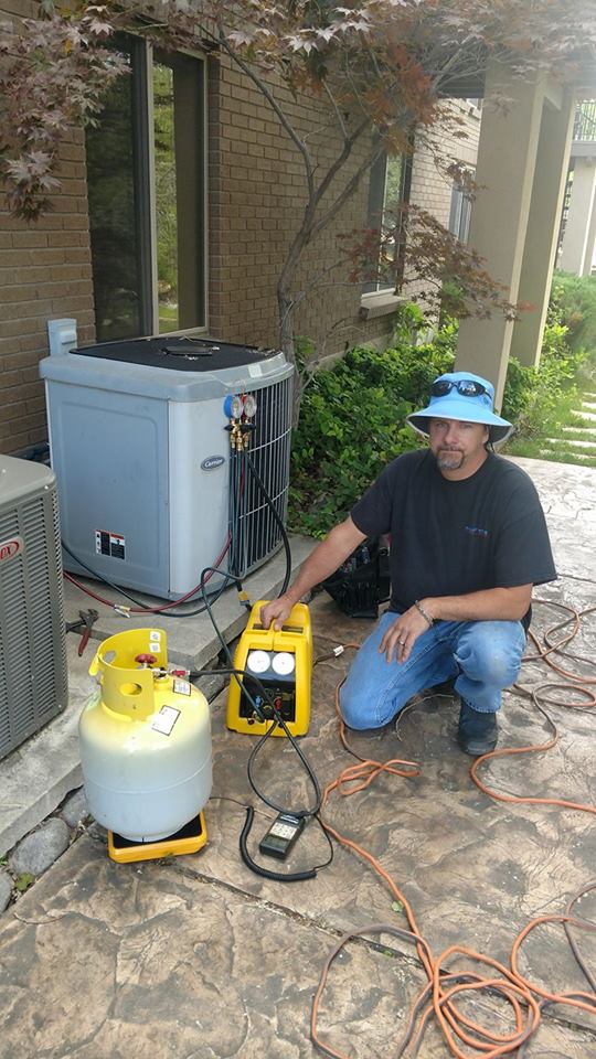 Man servicing an air conditioner