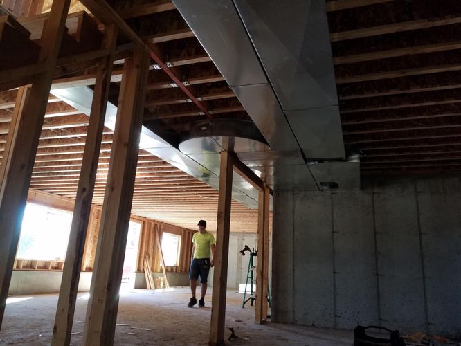 Person walking through newly constructed house frame